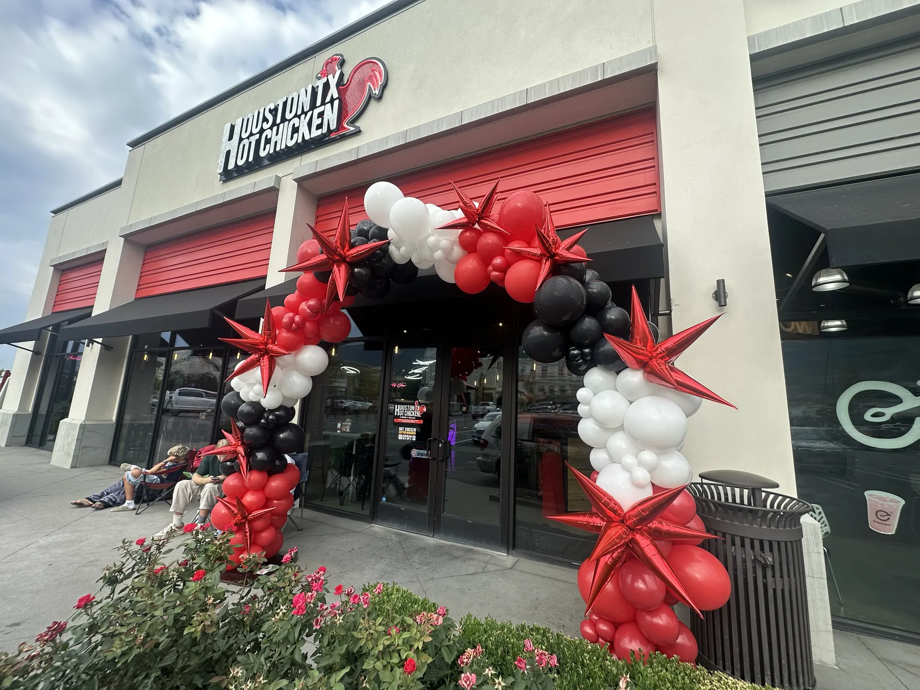 Large organic balloon arch with star accents for a corporate event